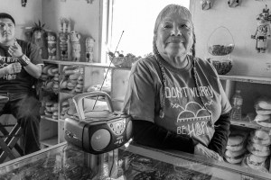 Janice Day listens to the radio at her store Tsakurshovi, where she sells traditional crafts to both tourists and locals. © Tomas Muscionico