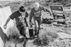 Paul Tso and Joseph Day haul an old battery off for proper disposal. A good portion of homes on Hopi do not have electricity and have relied on batteries and generators in the past, and, increasingly now, solar panels. © Tomas Muscionico